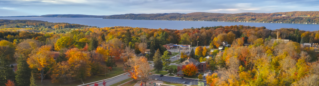Fall colors in Benzonia MI. Mills Community House with Crystal Lake in background. Photo by Elija Fly Photography
